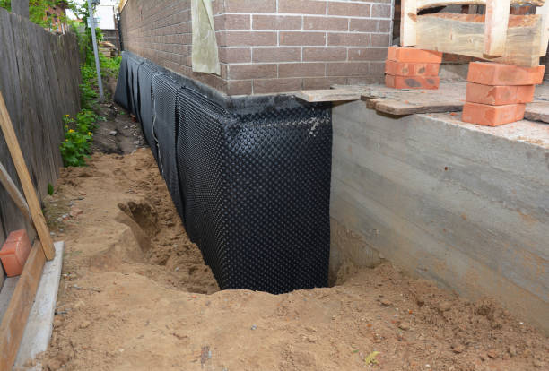 Happy homeowners after waterproofing job in Lowell